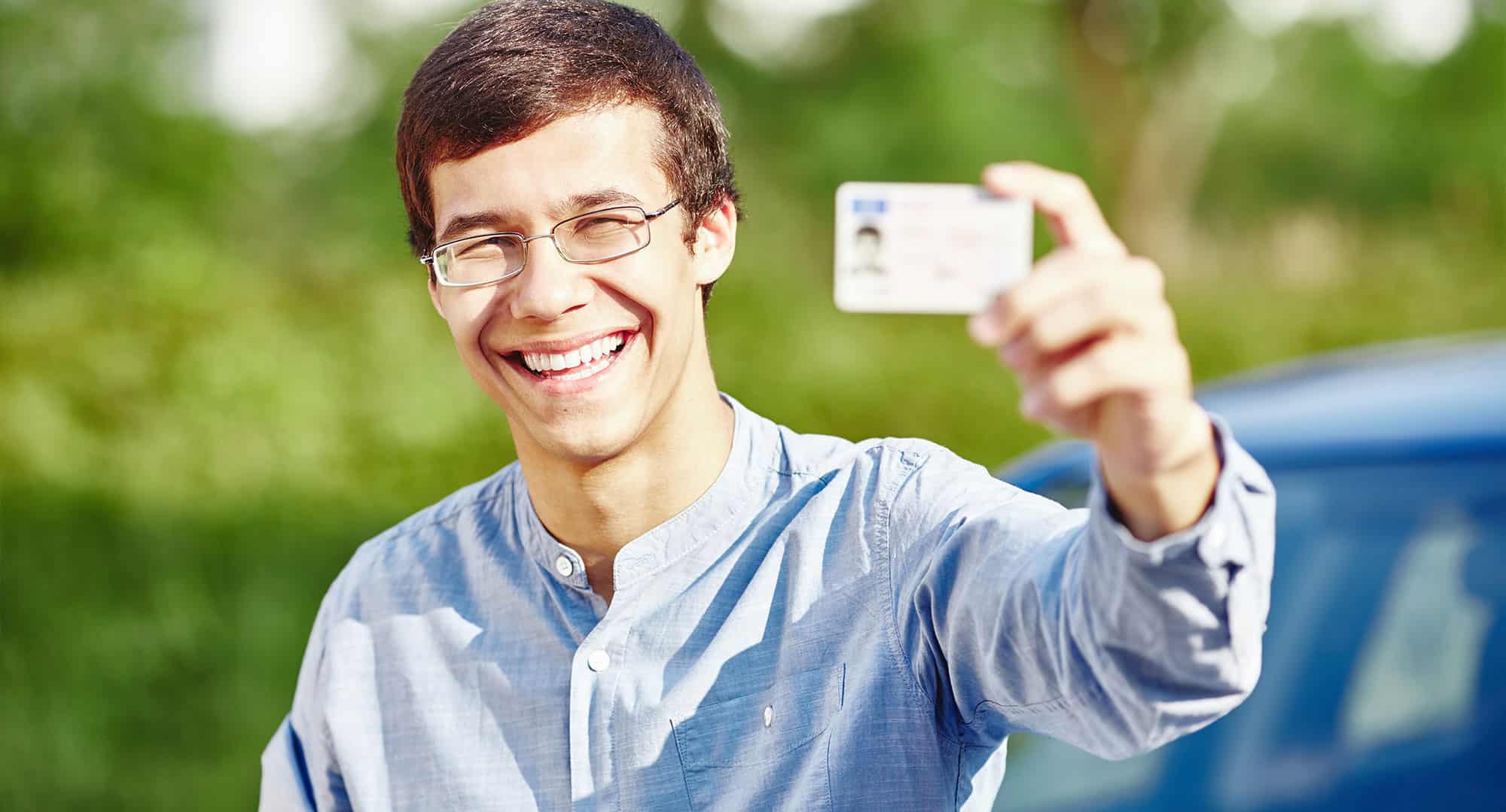 Male Teen Driver Student Holding Driver License